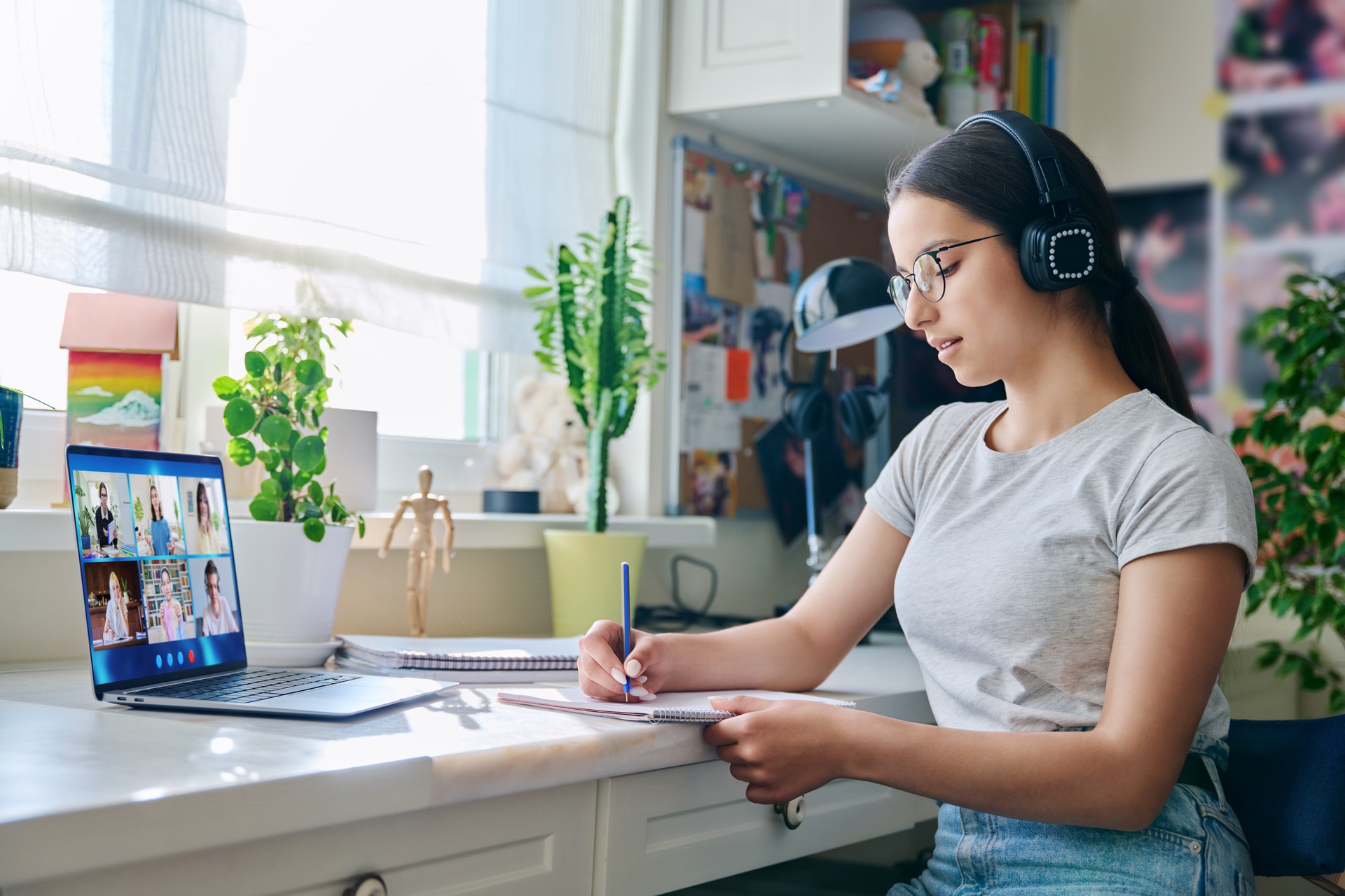 Video conference, teen girl looking at computer screen with group of students